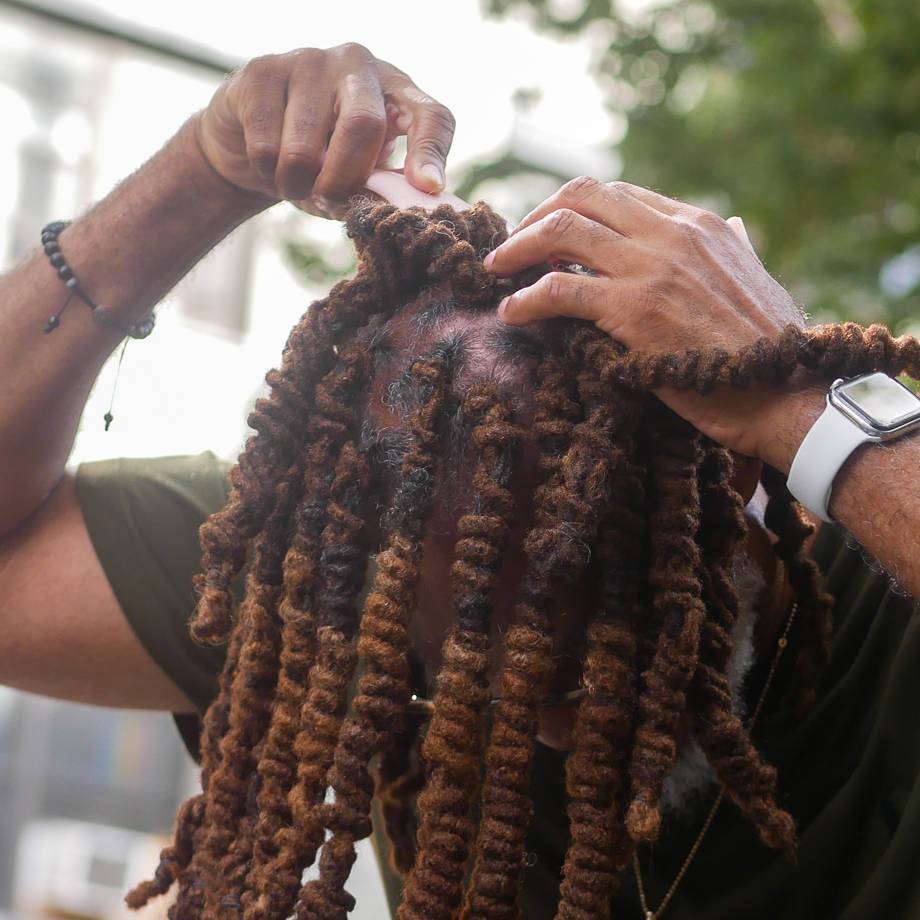 Man using cryotherapy scalp roller to relieve dry, itchy scalp and improve blood circulation for healthier hair growth.