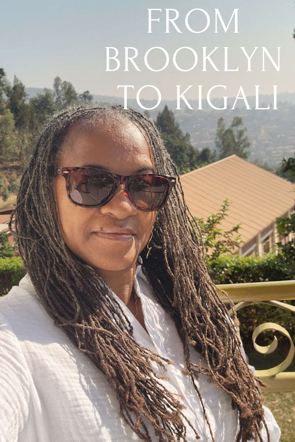 Person with dreadlocks wearing sunglasses with text 'FROM BROOKLYN TO KIGALI' against a scenic background.