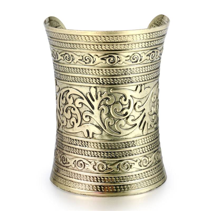 Close-up of an intricately designed gold hair cuff with engraved patterns. A perfect non-damaging ponytail holder for locs and braids.