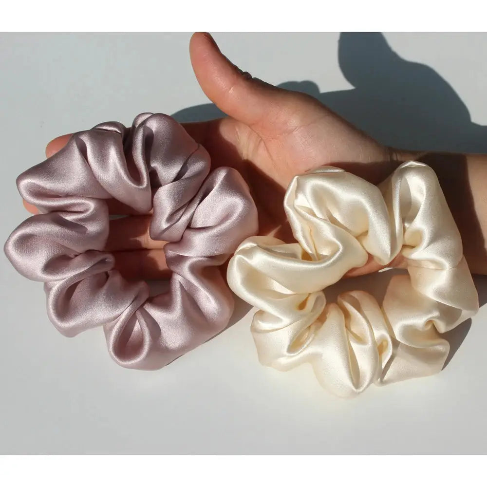 Large silver and ivory 100% pure mulberry silk scrunchies. Premium silk hair ties designed for smooth, tangle-free hair styling.
