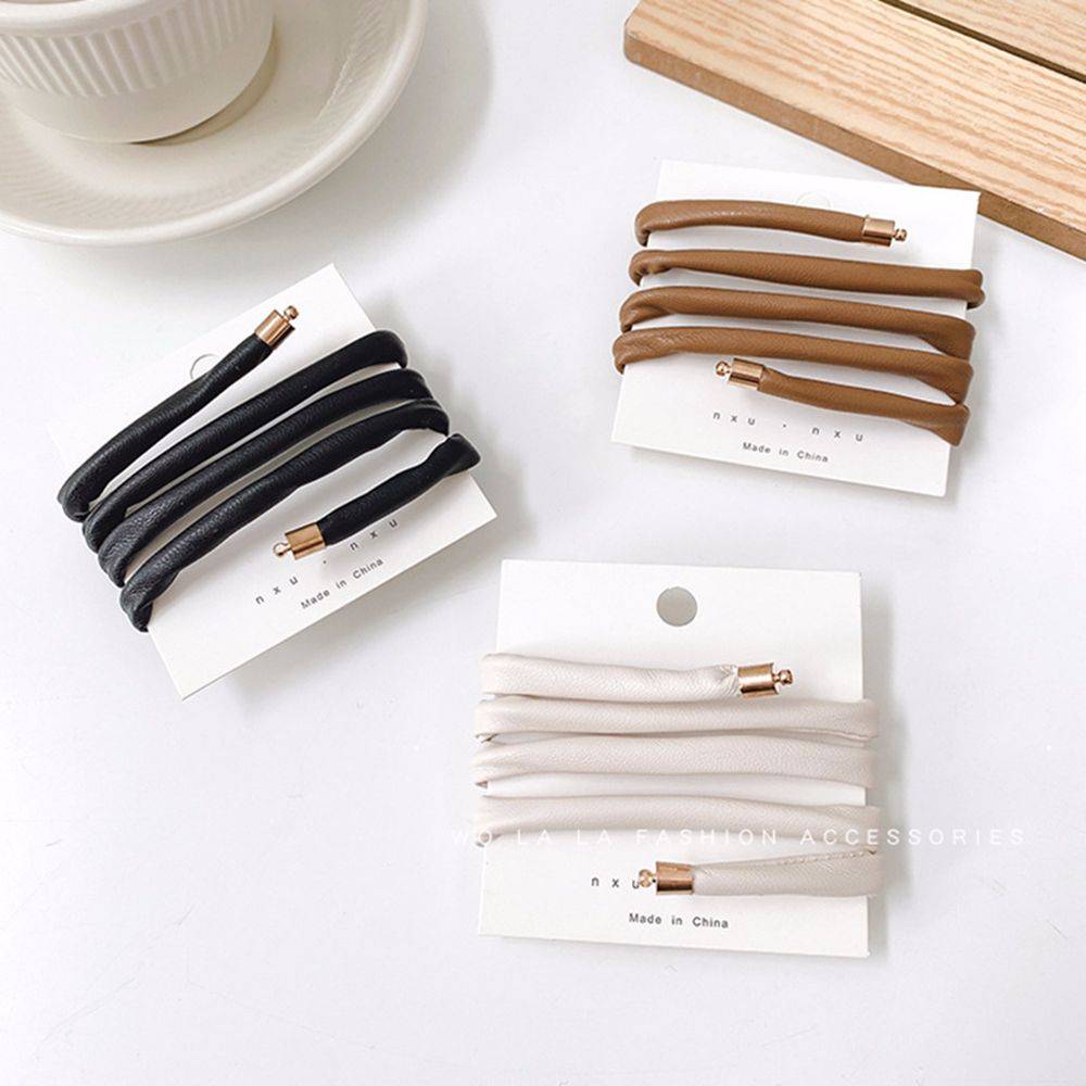 Three non-damaging ponytail holders in black, brown, and white on packaging. Perfect for securing locs, dreadlocks, braids, and sisterlocks.