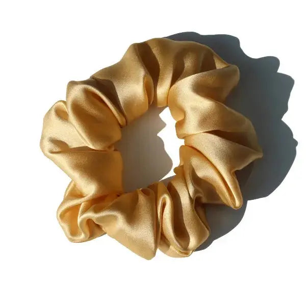 Beige 100% pure mulberry silk scrunchie. Large, soft silk hair tie for a neutral and stylish hair accessory.