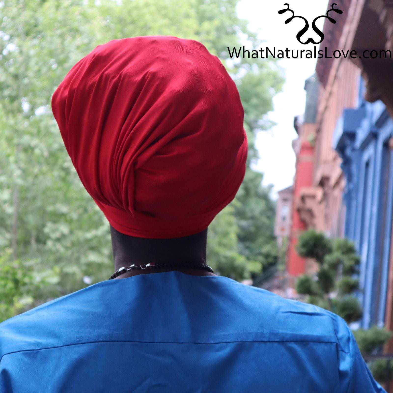 Back view of a man wearing a red tube headwrap for locs, sisterlocks, and dreadlocks. A stylish and protective headwear option.