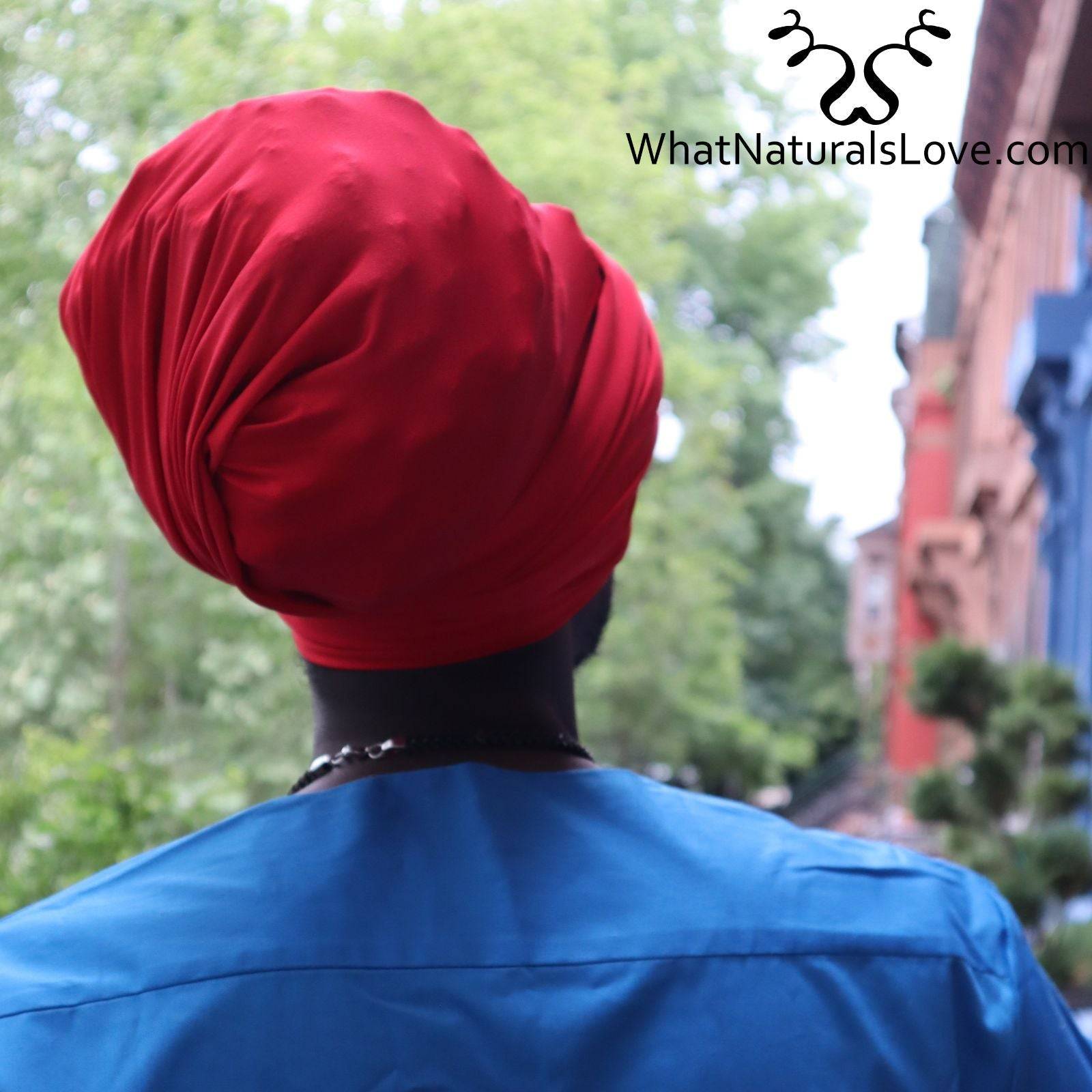 Back view of a man wearing a red tube headwrap for locs, sisterlocks, and dreadlocks. A stylish and protective headwear option.