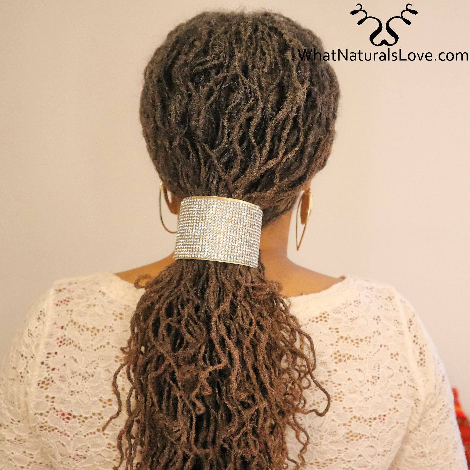 Back view of a woman with locs secured by a crystal-embellished hair cuff. Elegant and non-damaging accessory for styling locs and braids.