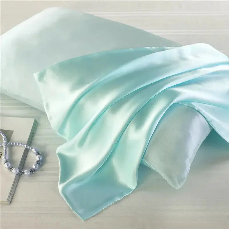 Pastel mint green natural mulberry silk pillowcase for locs. Smooth, breathable, and hypoallergenic for a luxurious and protective sleep experience.