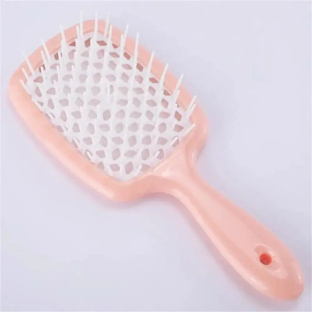 Black detangling brush with pink bristles, designed for curly hair. Helps reduce breakage and ensures smooth, effortless detangling.