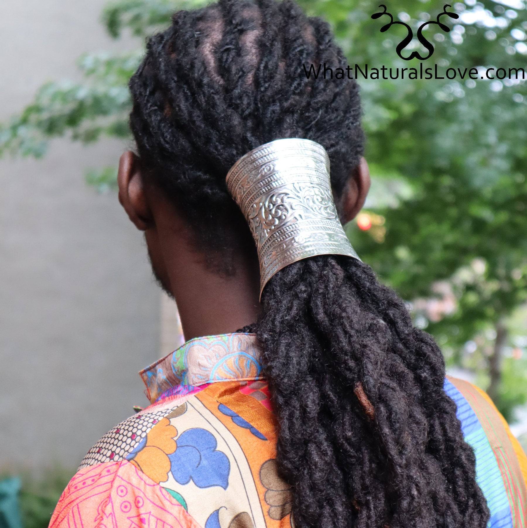 Silver hair cuff elegantly holding thick dreadlocks in a ponytail, worn by a man outdoors. Perfect for locs, Sisterlocks, and braids.