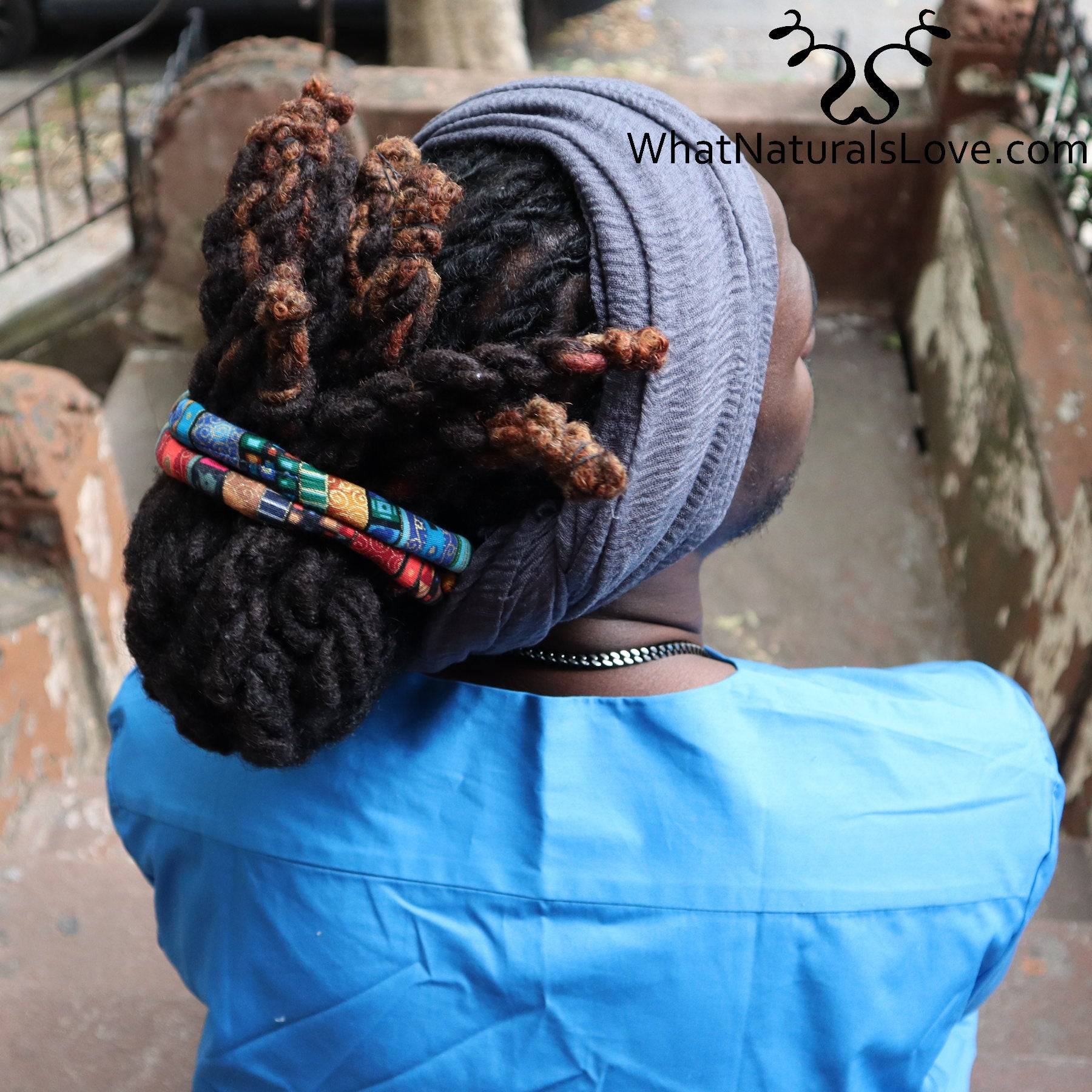Back view of a man wearing a breathable wrap for locs and dreadlocks. The extra-large headwrap keeps his hair neatly secured.