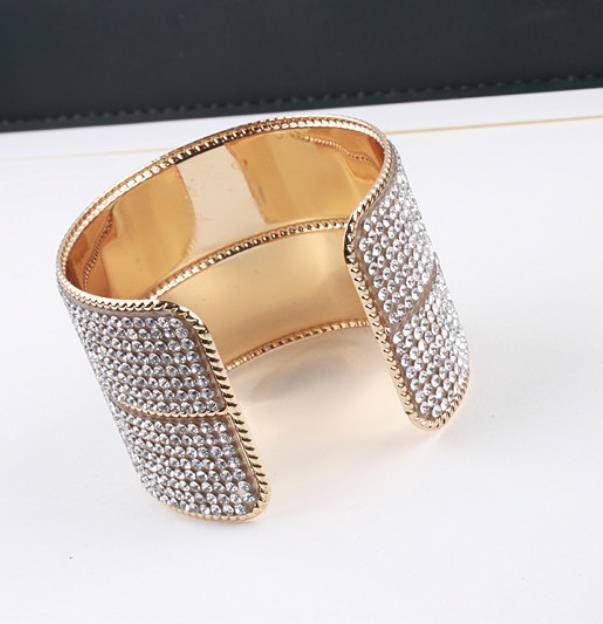 Gold hair cuff with crystal embellishments, featuring an open design. Ideal for securing locs, braids, and twists in a stylish way.