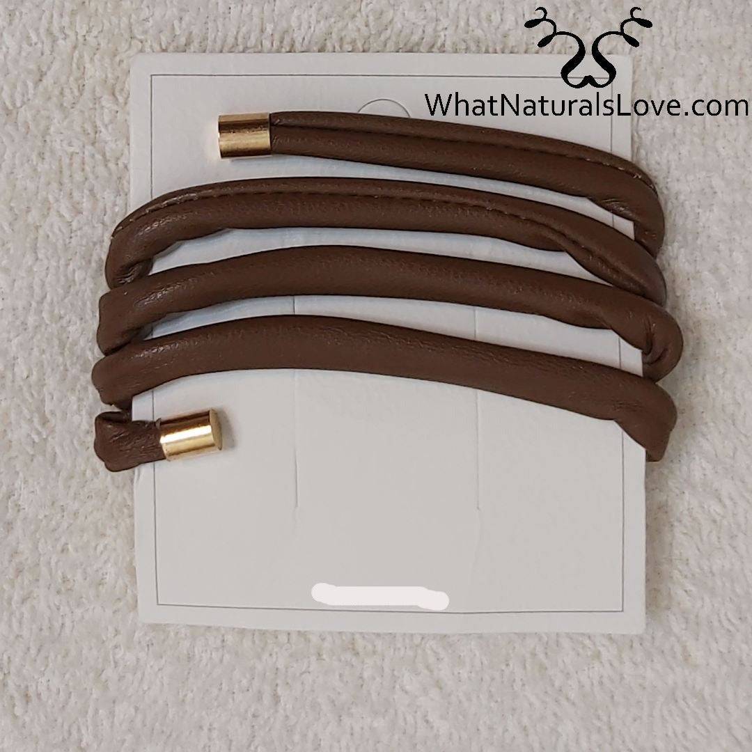 Brown non-damaging ponytail holder for locs on a white card. Easy-to-use hair tie for dreadlocks, braids, and sisterlocks with gold-tone tips.