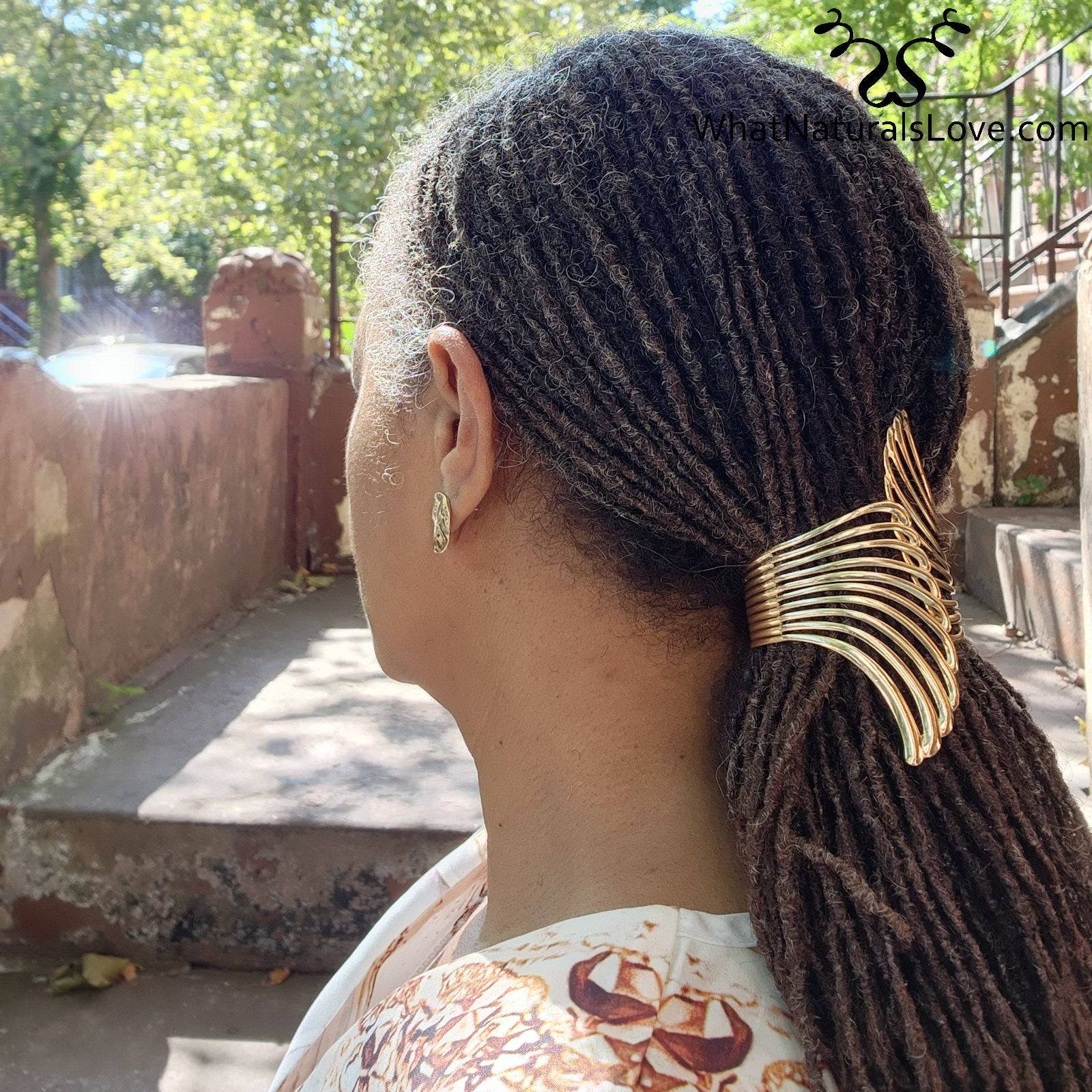 Side view of Gold Aurora Wing Cuff holding sisterlocks in a ponytail. Perfect for styling locs, dreadlocks, and braids with a unique touch.