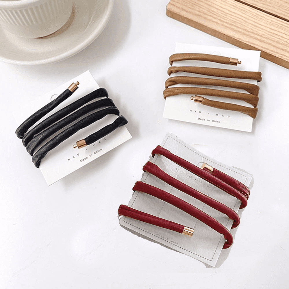 Set of red, black, and brown ponytail holders for locs on display. Non-damaging hair ties designed for dreadlocks, braids, and sisterlocks.