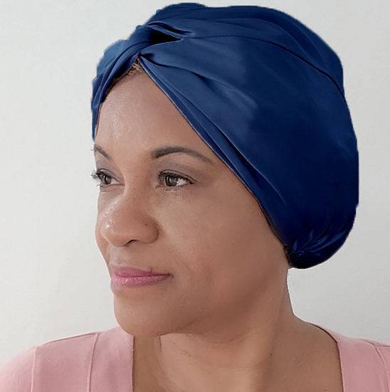 Silk Bonnet Amara De Luxe in deep blue, featuring a twisted front. Made from 100% Mulberry Silk to maintain moisture and prevent hair breakage.