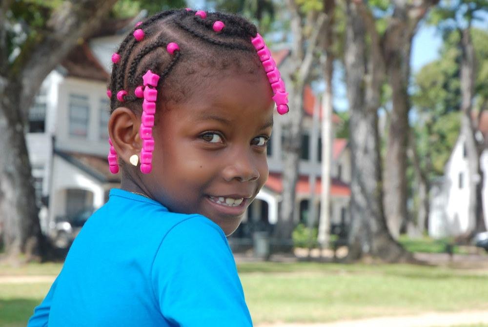 Suriname kid with natural hair in braids and beads 