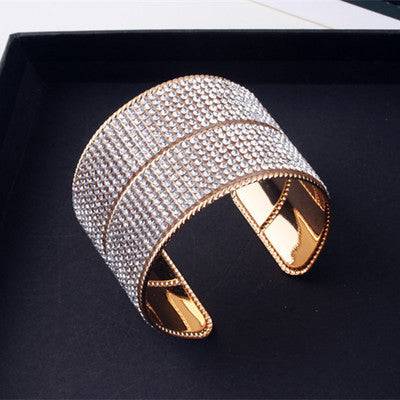Gold and crystal hair cuff displayed on a black surface. Perfect for styling locs, braids, and twists with a secure and elegant hold.