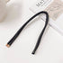 Black non-damaging ponytail holder for locs placed on a book. Ideal hair tie for dreadlocks, braids, and sisterlocks with gold-tone tips.