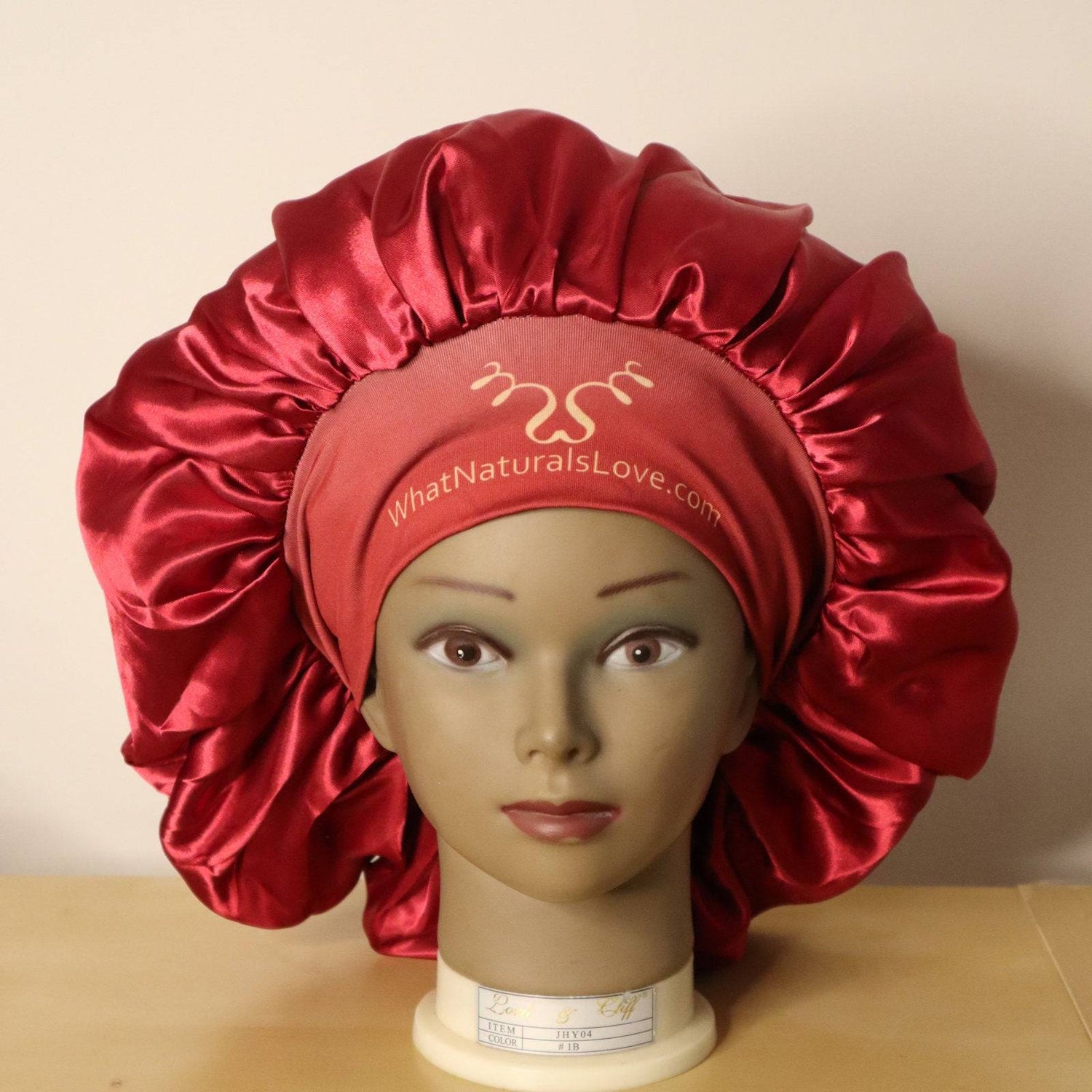 Super Comfi Large Satin Bonnet for Locs in deep red displayed on a mannequin. Satin-lined, tie-on design prevents hair damage and retains moisture.