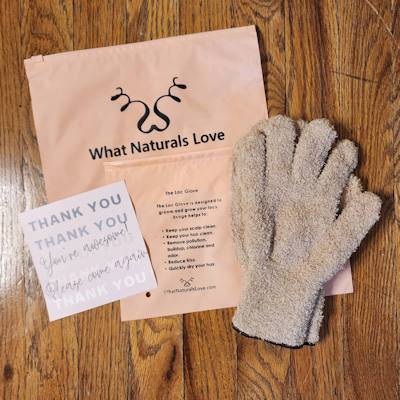 What Naturals Love exfoliating glove with branded packaging and thank-you note, designed for scalp and loc care to remove buildup and improve circulation.