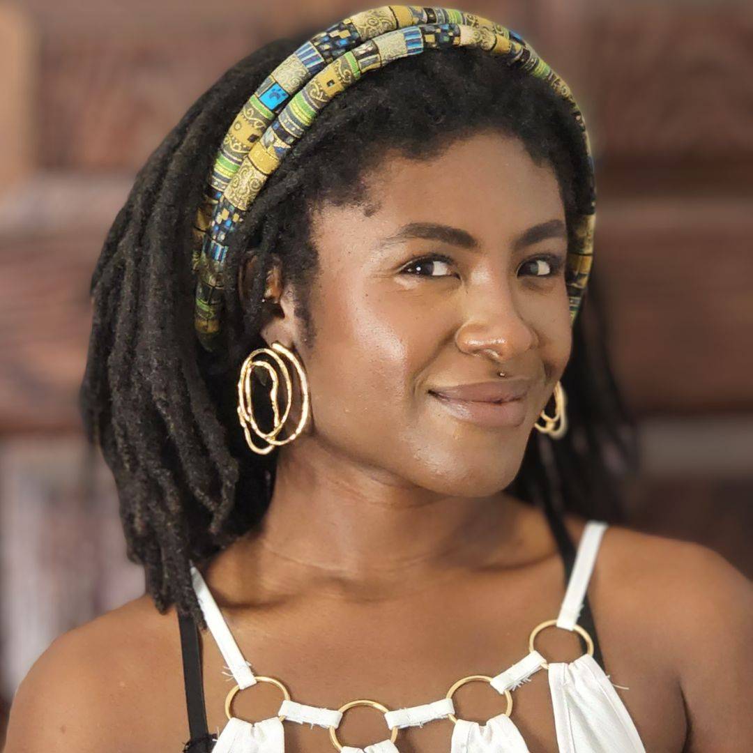 Woman wearing a moldable hair tie as a headband for locs. Handmade and stylish, ideal for Sisterlocks, braids, and afro puffs.