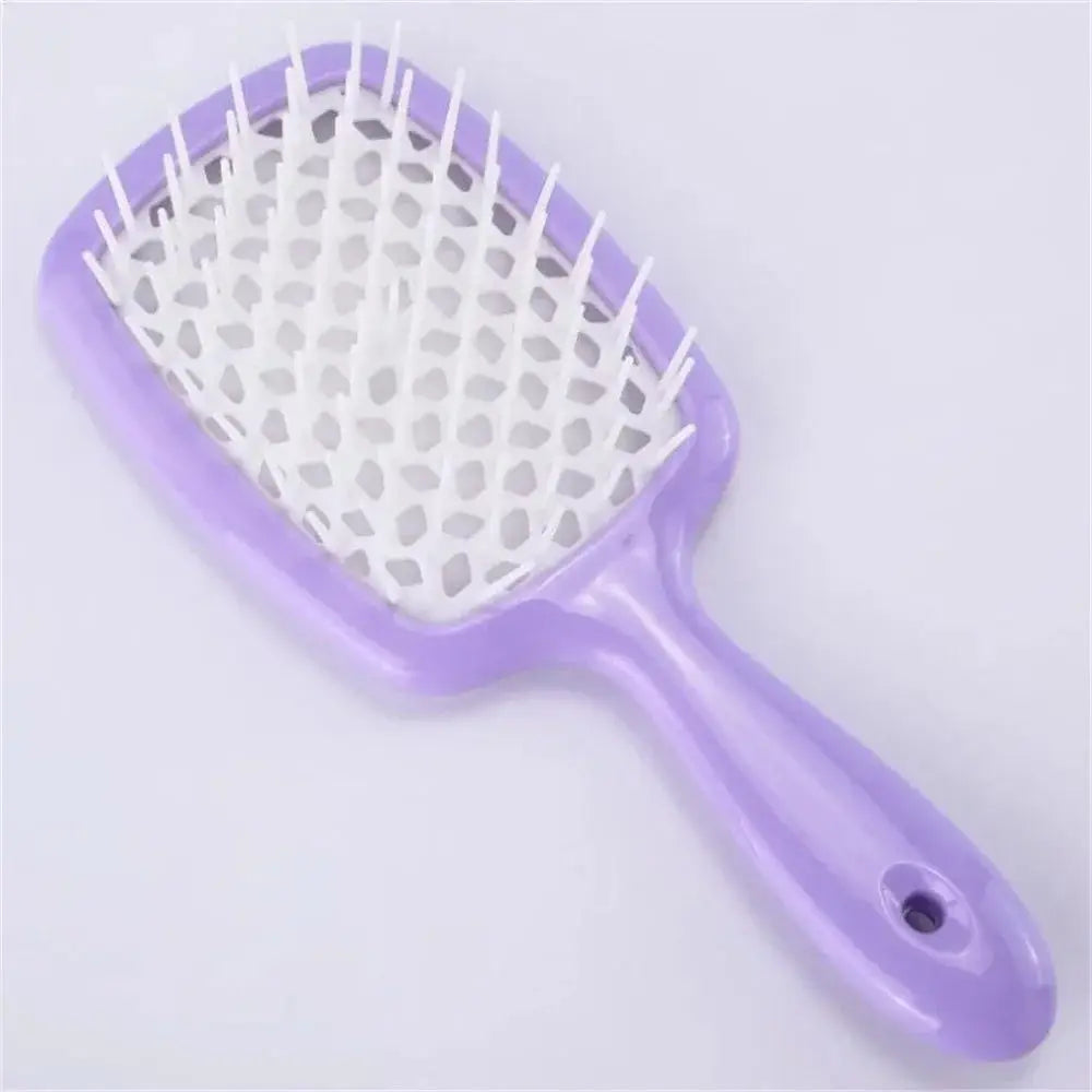 Transparent detangling brush with peach-colored bristles for curly hair. Designed for pain-free detangling and reducing hair breakage.