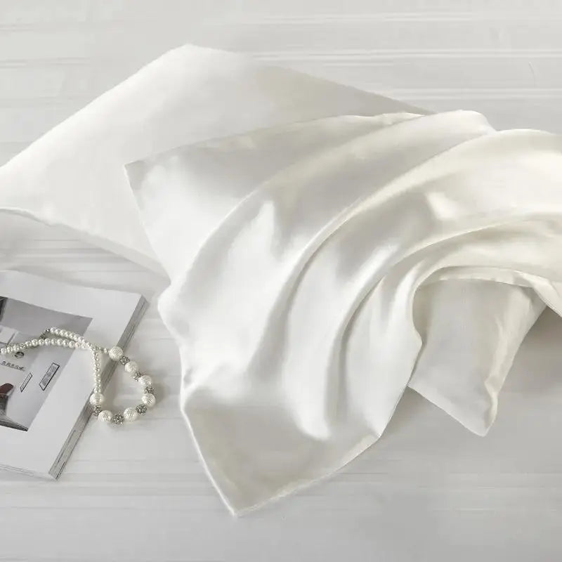 Elegant white natural mulberry silk pillowcase for locs. Ultra-soft, breathable, and designed to protect hair from frizz and breakage.