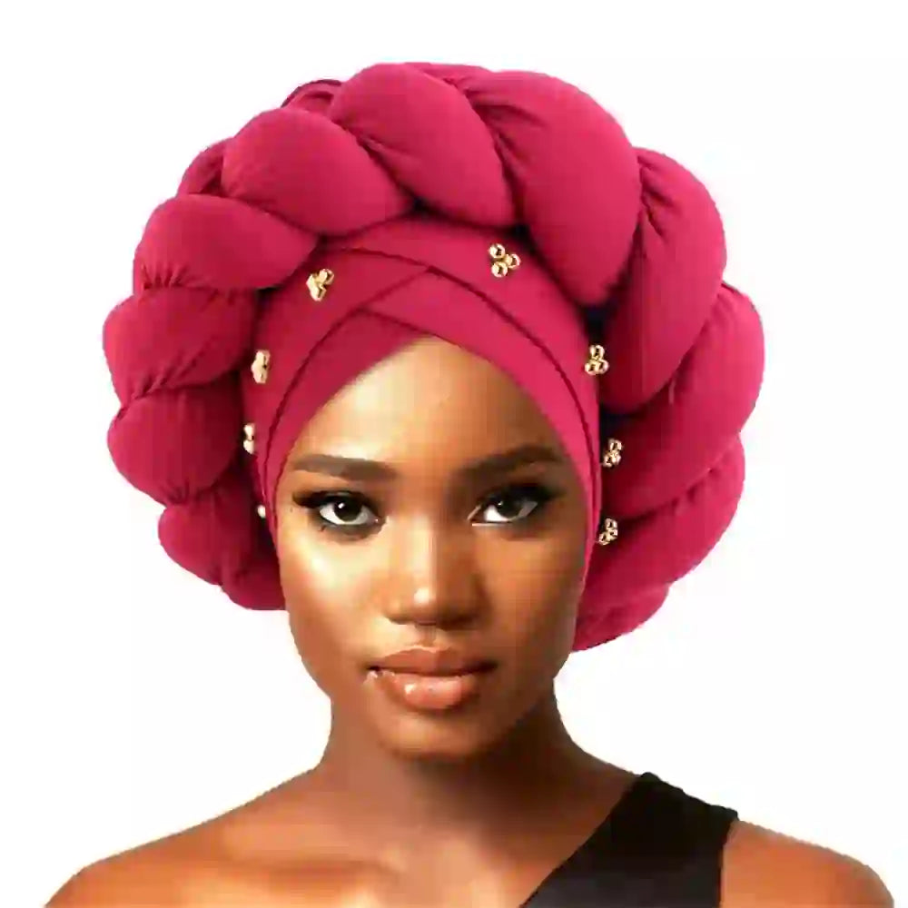 Wine red Gele African turban for women with braided design and gold bead embellishments. Elegant headwrap for traditional and modern styling.