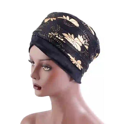 Black Regal Amethyst Adorned Headwrap with gold floral accents, displayed on a mannequin. A stylish and versatile headwrap for women.