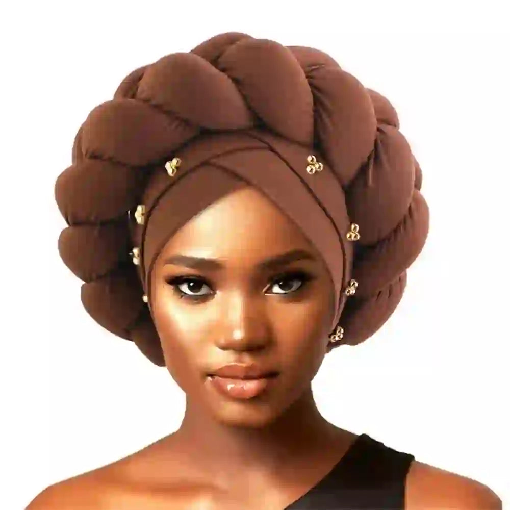 Coffee brown Gele African turban for women with a braided design and gold bead accents. A sophisticated headwrap for cultural events.