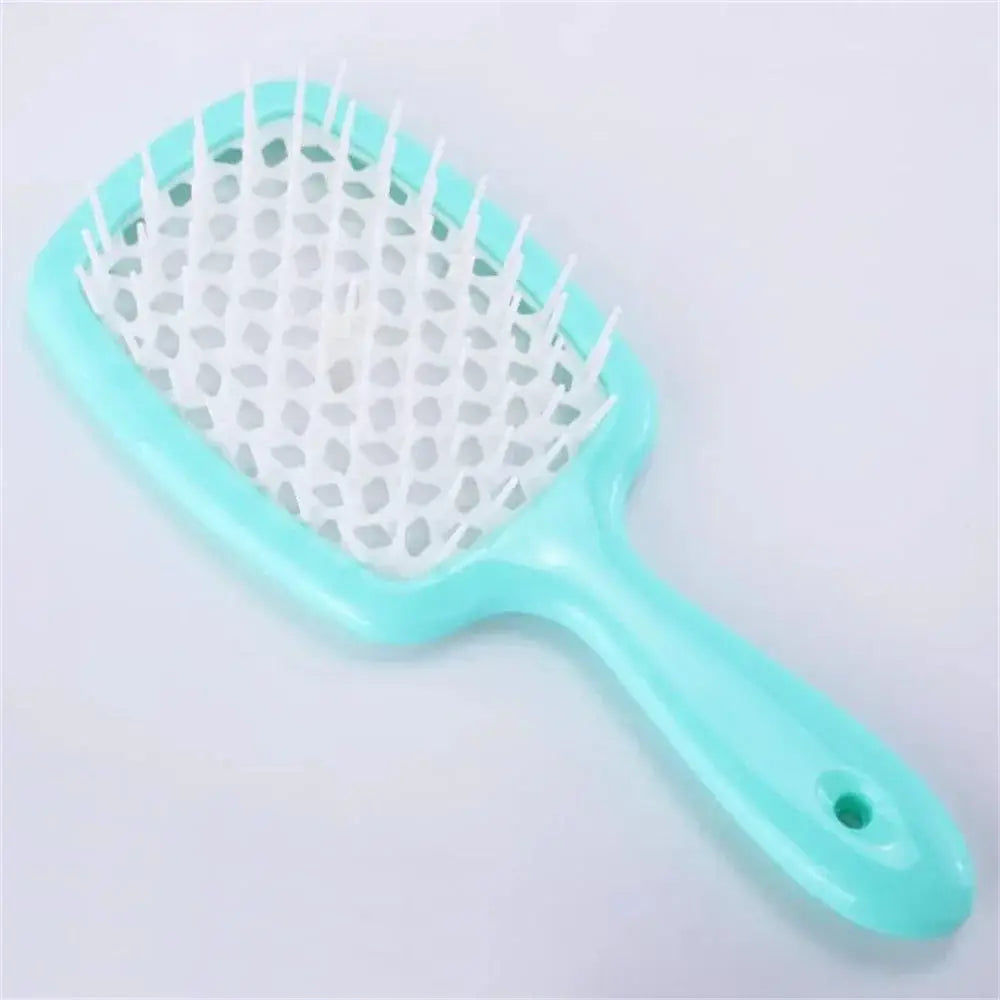 Black detangling brush with mint green bristles for curly hair. Designed for pain-free detangling and reducing hair breakage.
