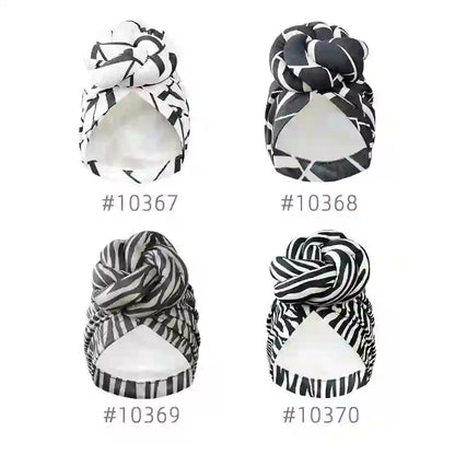 Four different patterned knot turban headwraps labeled with unique design numbers, showcasing stylish geometric prints in black and white.