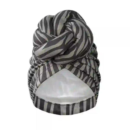 Close-up of a black and gray striped patterned knot turban headwrap, designed for soft comfort and elegant styling.