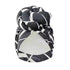 Black and white geometric patterned knot turban headwrap with a dark base, offering a sophisticated and stylish headwear option.