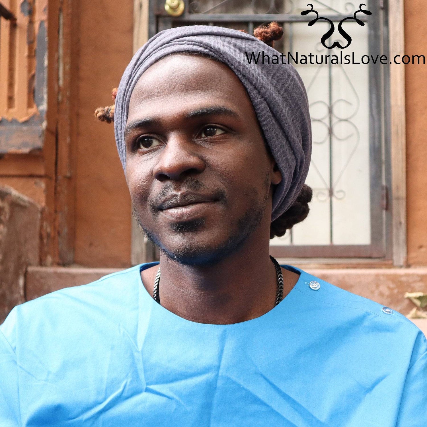 Side view of a man wearing a breathable wrap for locs and dreadlocks. The large headwrap secures his hair stylishly and comfortably.