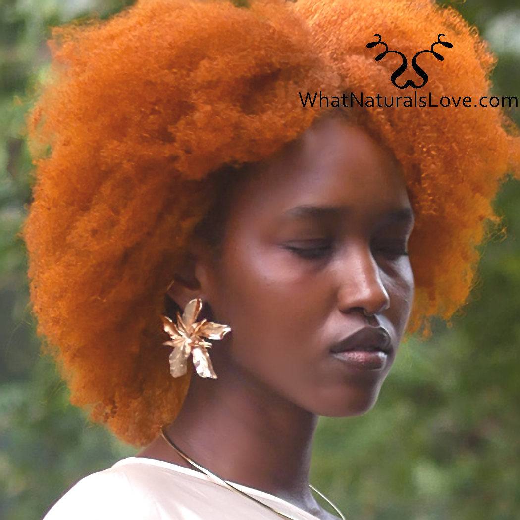 Kadija Luxe Bloom Earrings worn by a model with natural curly hair, showcasing their bold floral design in gold-tone metal.